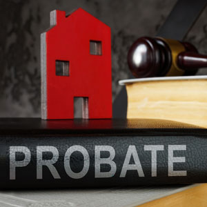 An image depicting a book titled "Probate" alongside a house model and a gavel, symbolizing the probate process in the california - Preston Law Group, P.C